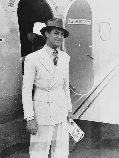 carygrant DB Man standing in front of aeroplane door.