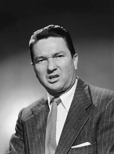 Vintage businessman sneering at camera.