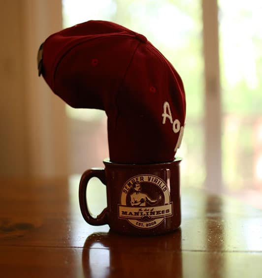 A baseball cap turned into in coffee mug. 