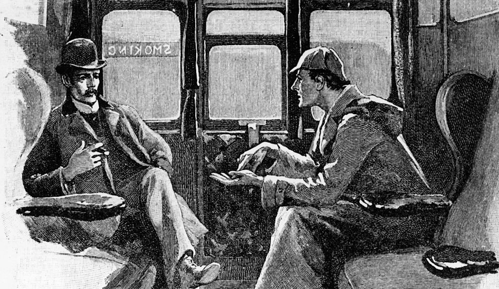 Two men sitting in a train chatting with each other about a podcast they enjoy.